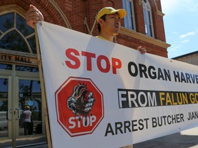 In this file photo, a practitioner of Falun Gong protests the forced harvesting of human organs in China.