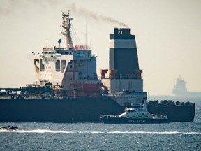 Royal Marine patrol vessel is seen beside the Grace 1 super tanker in the British territory of Gibraltar, Thursday, July 4, 2019.