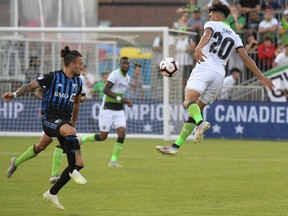 York9 forward Diyaeddine Abzi leaps to block a pass by Montreal Impact forward Maxi Urrutti in the first half  at York Lions Stadium on July 10.