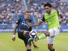 Impact's Maximiliano Urruti and York9 FC's Manuel Aparicio battle for the ball during Canadian Championship action Wednesday night at Saputo Stadium.