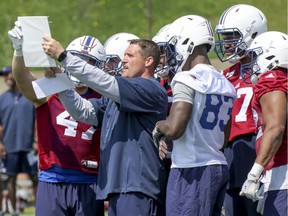 Alouettes special teams coach Mickey Donovan holds up play sheet during training camp. Allowing two kick returns to go for touchdowns against the Redblacks last week "was disappointing for sure," he says.