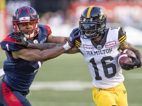 Montreal Alouettes' Ciante Evans pushes Hamilton Tiger-Cats' Brandon Banks out of bounds during game in Montreal on July 4, 2019.