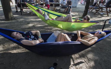 MONTREAL, QUE.: AUGUST 2, 2019 -- Jeremy Hadfield and Nikita Hoehn relax on day 1 of the Osheaga Music and Arts Festival at Parc Jean-Drapeau in Montreal Friday, August 2, 2019. (John Kenney / MONTREAL GAZETTE) ORG XMIT: 62919