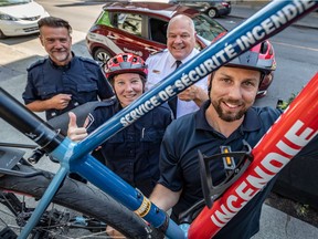 The Service de sécurité incendie's (SIM) two-wheeled crew is inspecting buildings mostly in the Ville-Marie borough. Geneviève Tremblay and Kevin Francoeur, fire prevention agents in the foreground, Christian Plouffe, both technical agent and Alain Rouleau, Assistant Director Fire Safety Service, left to right in the background, were on hand in Montreal.