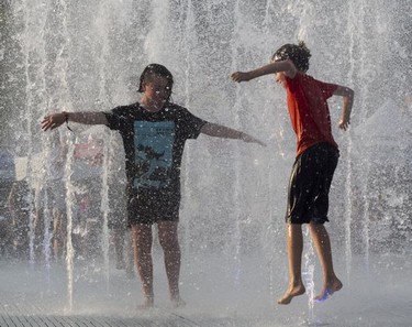 Youngsters play in the fountain on Day 2 of the Osheaga Music and Arts Festival at Parc Jean-Drapeau in Montreal Saturday, August 3, 2019.