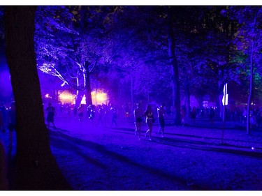 People walk on the grounds of the Osheaga Music and Arts Festival at Parc Jean-Drapeau in Montreal Saturday, August 3, 2019.