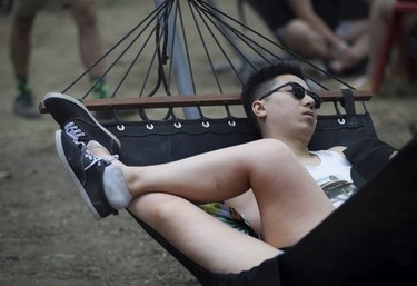 Richard Chang takes a snooze with his fiancée Marissa Kaufman on Day 2 of the Osheaga Music and Arts Festival at Parc Jean-Drapeau in Montreal Saturday, August 3, 2019.