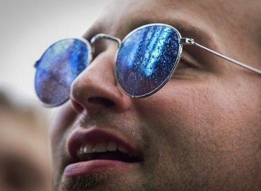 A man watches rapper ScHoolboy Q perform after getting sprayed with water on Day 2 of the Osheaga Music and Arts Festival at Parc Jean-Drapeau in Montreal Saturday, August 3, 2019.