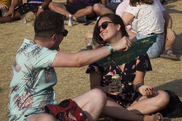 Tom Corken fans Marilyn Kehl on Day 2 of the Osheaga Music and Arts Festival at Parc Jean-Drapeau in Montreal Saturday, August 3, 2019.