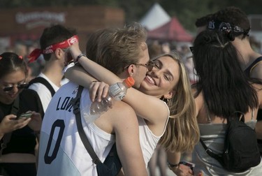 Ryan Grube and Andrea Vucetic embrace on Day 2 of the Osheaga Music and Arts Festival at Parc Jean-Drapeau in Montreal Saturday, August 3, 2019. They are both Torontonians, but Vucetic is studying here.
