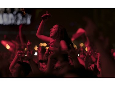 People get into Logic's set on Day 2 of the Osheaga Music and Arts Festival at Parc Jean-Drapeau in Montreal Saturday, August 3, 2019. (John Kenney / MONTREAL GAZETTE)