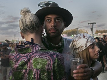 Kai Henry, with Grace Stavert (left) and Domonique Abbondante wait near a stage for the next show to start on day 3 of the Osheaga Music and Arts Festival at Parc Jean-Drapeau in Montreal on Sunday, August 4, 2019.
