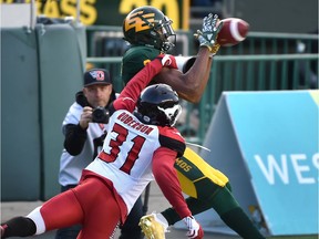 Edmonton Eskimos Kenny Stafford (8) makes the catch to score a touchdown on Calgary Stampeders Tre Roberson (31) during third quarter CFL action at Commonwealth Stadium in Edmonton, September 8, 2018.