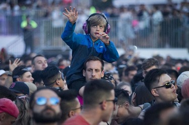 A youngster gets into the music of the artist Kaskade on Day 1 of the ÎleSoniq electronic music festival at Parc Jean-Drapeau in Montreal on Friday, August 9, 2019.