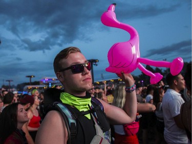 A man and his flamingo in  the crowd for the artist Kaskade on Day 1 of the ÎleSoniq electronic music festival at Parc Jean-Drapeau in Montreal on Friday, August 9, 2019.