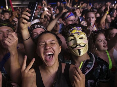 People enjoy the music on Day 1 of the ÎleSoniq electronic music festival at Parc Jean-Drapeau in Montreal on Friday, August 9, 2019.