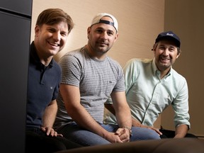 Left to right: Simon Proulx and Charles Dubreuil of the band Les Trois Accords  are seen with celebrity chef Bob le chef, a.k.a. Robert James Penny, in Montreal, on Tuesday, Aug. 13, 2019.