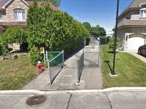 The Kirkland side of a pathway that is locked overnight at the entrance leading to Pierrefonds.