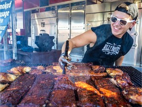 Maverick applies barbecue sauce to the ribs on the Billy Bones grill at the Grand Ribfest in Old Montreal on Thursday, Aug. 15, 2019.