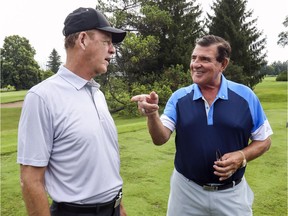 Former Canadien Bobby Smith, left, and former Habs player and GM Serge Savard reminisce at Savard's annual golf tournament at Islesmere Golf Club in Laval on Monday.