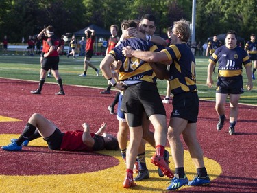 Town of Mount Royal RFC's  Stanislas Blazkowski (15) is congratulated by teammates after he scored against Club de Rugby de Québec during the Quebec Cup Rugby Super League Final in Montreal on Saturday, Aug. 24, 2019.