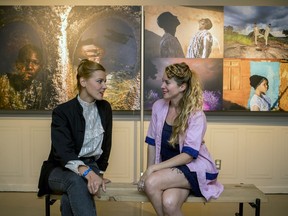 Bénédicte Kurzen, left, and Sanne De Wilde, with their prize-winning work at the World Press Photo exhibit in Montreal Aug. 27, 2019.  The two were cited for their series of portraits of twins in Nigeria.