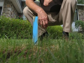 A blue stake on the lawn of a Kirkland home in 2011 was used to identify it as having cross-connected sewage pipes that need to be fixed. This year, more Kirkland homes are being inspected for crossed sewer pipes.