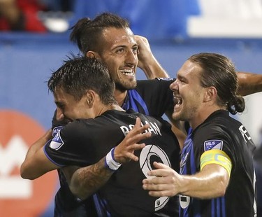 Montreal Impact's Maximiliano Urruti celebrates his goal against the Vancouver Whitecaps with team-mates Bojan and Samuel Piette on Aug. 28, 2019.