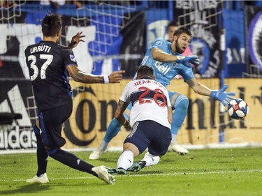 The Montreal Impact's Maximiliano Urruti shoots past Vancouver Whitecaps defender Jakob Nerwinski and keeper Maxime Crepeau for the team's second goal of the game during first half MLS action in Montreal on Wednesday August 28, 2019.  (John Mahoney / MONTREAL GAZETTE) ORG XMIT: 63061 - 3664