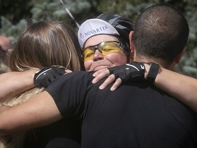 Novartis employee Jocelyne Aubry gets a hug from her children Katherine and Joel Durandeau after completing a 600 km Ride of Hope from Toronto to Dorval.