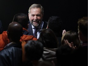 NDP leader Tom Mulcair is greeted by supporters as he arrives to deliver a speech to party supporters in Montreal on Monday October 19, 2015.