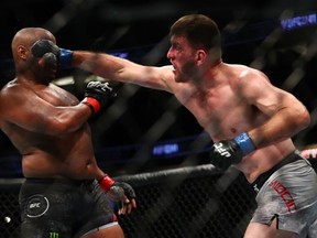 Stipe Miocic throws a punch at Daniel Cormier in the second round during their UFC Heavyweight Title Bout at UFC 241.