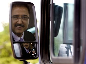 Former transit driver and then city councillor Amarjeet Sohi hits a few barrels as he drives a bus through a course to test the drivers skills during a transit rodeo in Edmonton.