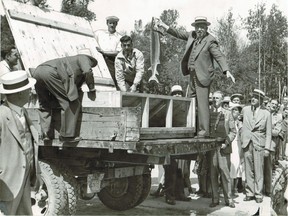 This photo from our archives, evidently taken Aug. 26, 1939, shows people gathered around the truck that had brought fish from Valleyfield. Among the dignitaries present were Quebec Labour Minister William Tremblay, minister without portfolio T.J. Coonan and W.R. Bulloch, who represented Westmount in the legislative assembly. Information accompanying the photo seems to indicate that Bulloch is the one holding the sturgeon, but that is not entirely clear.