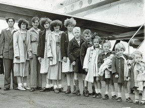 The 14-member Van Bussel family arrives at Montreal Airport from the Netherlands as immigrants on a Royal Dutch Airlines "Royal Dutchman" flight. The family was headed for Lucan, Ont., where they were going to live on a farm. Our story about the family's arrival ran on Aug. 12, 1950. The 12 children are pictured above. The parents are included in the uncropped version that appears with the text.