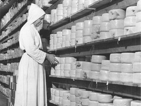 A  monk at the Benedictine Abbey at St-Benoît-du-Lac, in Quebec's Eastern Townships, handles the abbey's famous Ermite blue cheese, in a photo published in the Montreal Gazette on Aug. 11, 1956.