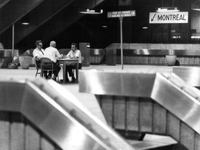 In this photo published on the front page of the Montreal Gazette on Aug. 16. 1974, transit employees play cards in an empty Île-Sainte-Hélène station. A strike by maintenance and garage workers had caused the métro to be shut down.