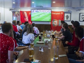 People watch a streaming of Liverpool team face Arsenal in the English Premier League from the Burgundy Lion Pub in Montreal on Saturday, August 25, 2019. This game, and all other EPL matches, are exclusively broadcast in Canada by streaming service DAZN as of this season.