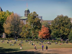 Students sit outside McGill University campus on Oct. 12, 2016.