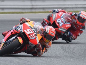 Repsol Honda Team's Spanish rider Marc Marquez (L) and Mission Winnow Ducati's Italian rider Andrea Dovizioso compete during the Moto GP Czech Grand Prix in Brno on August 4, 2019.