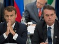 In this file photograph taken on June 28, 2019, France's President Emmanuel Macron (L) and Brazil's President Jair Bolsonaro attend a meeting on the digital economy at the G20 Summit in Osaka.