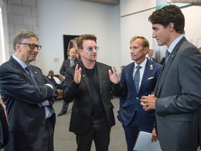 Bill Gates, left, Bono, former Global Fund executive director Mark Dybul and Justin Trudeau hold an impromptu meeting at the Fifth Replenishment Conference of the Global Fund to Fight AIDS, Tuberculosis and Malaria in Montreal in September 2016.
