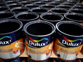Dulux paint cans wait to be filled inside AkzoNobel's new paint factory in Ashington, Britain