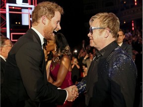 Britain's Prince Harry greets Elton John after the Royal Variety Performance at the Albert Hall in London, Nov. 13, 2015.