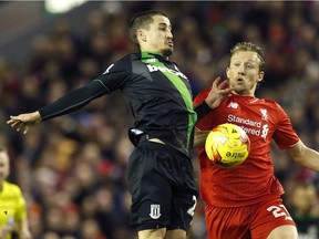 Stoke's Bojan Krkic, left, battles Liverpool's Lucas Leiva during English League Cup semifinal second leg match at Anfield stadium in Liverpool, England, Tuesday, Jan. 26, 2016.