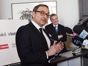 CP-Web. Martin Cauchon, of the Groupe Capitales Media, announces the purchase of six newspapers that were owned by Gesca, with president and director general Claude Gagnon, rear, Wednesday, March 18, 2015 in Quebec City. The Quebec newspaper chain has filed for creditor protection Monday.