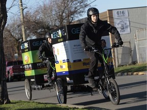 File photo shows two delivery people on cargo bikes in Victoria, B.C. Electric versions of the bikes will be used in Ville-Marie borough starting Sept. 1.