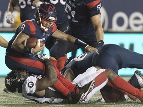 Alouettes quarterback Vernon Adams is tackled hard during game at Molson Stadium against the Redblacks Friday night in Montreal.