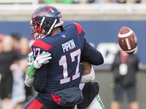 Alouettes quarterback Antonio Pipkin loses the ball as he's tackled by Saskatchewan Roughriders' Derrick Moncrief in Montreal on Friday, August 9, 2019.