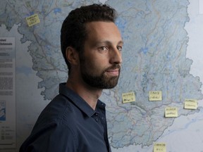 Ottawa Riverkeeper executive director Patrick Nadeau stands in front of a map showing the watershed of the Ottawa River.